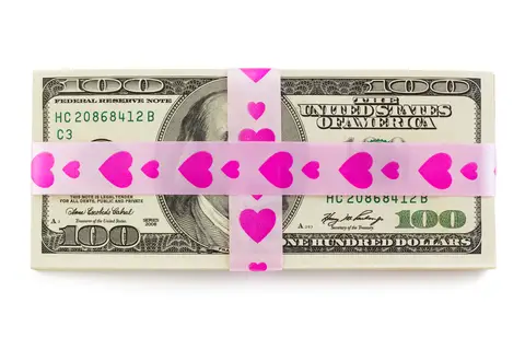 © 18042011e | Dreamstime.com - Stack Of Money Tied Up By Pink Ribbon With Hearts Photo