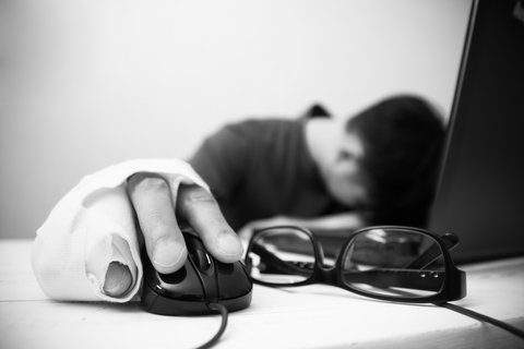 © Ampcool22 | Dreamstime.com - Photo Of A Man With Injuries Trying To Work On His Computer Photo